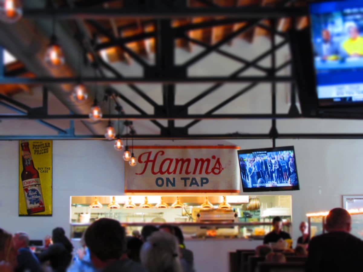 An antique Hamms beer sign hangs above the opening to the kitchen at Third Street Social.