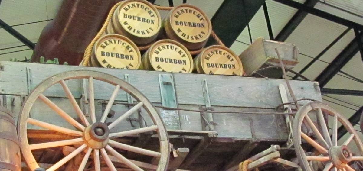 Wooden barrels of bourbon are secured to an old wagon in a display at the Arabia Steamboat Museum.