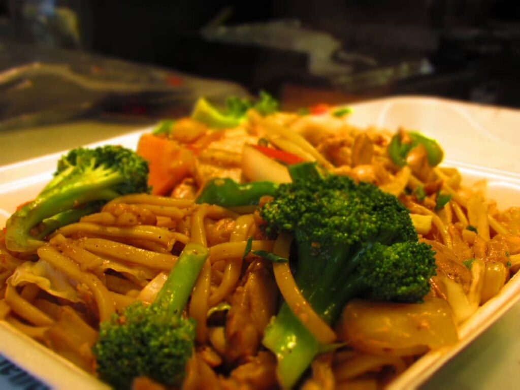 Lo mein noodles are cooked to tender perfection, and served with lots of vegetables. These include broccoli, carrots, onion, water chestnut slices, and diced peppers.