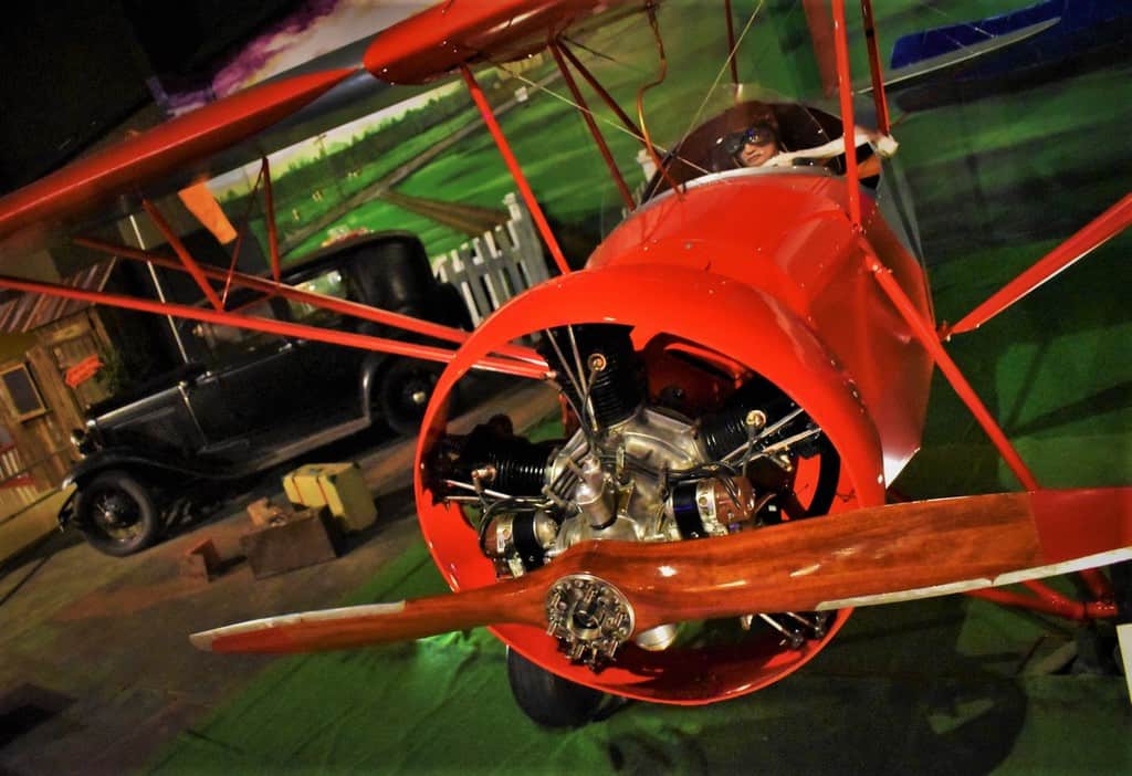 A pilot prepares to take to the skies in his airplane manufactured by the Nicholas-Beazley Airplane Company.