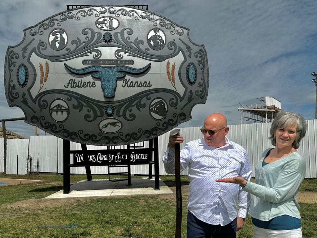 The authors pose with the World's Largest Belt Buckle.